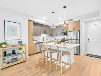 Chef-inspired kitchens featuring stainless steel appliances, custom dual tone cabinetry with 42” wall cabinets, quartz counter tops and tile backsplash